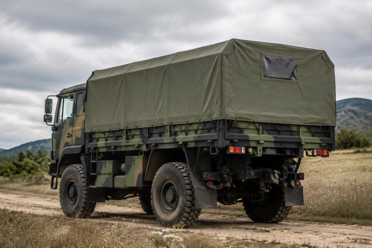Custom fitted military vehicle canvas cover installed on a tactical truck in field conditions