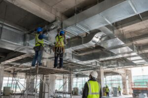Industrial ventilation duct installation on a construction site
