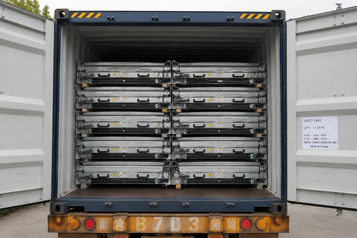 Stacked folded collapsible duct units in a standard shipping container